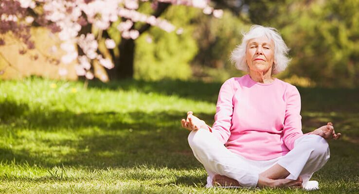 elderly woman meditating with hip osteoarthritis